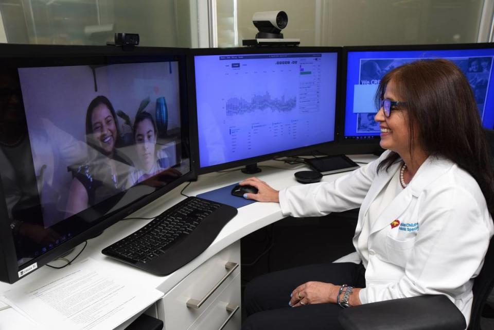 Dr. Adriana Carrillo-Iregui, a pediatric endocrinologist at Nicklaus Children’s Hospital, demonstrates the hospital’s telehealth system, which has been so important in keeping patients and doctors in touch during the pandemic.