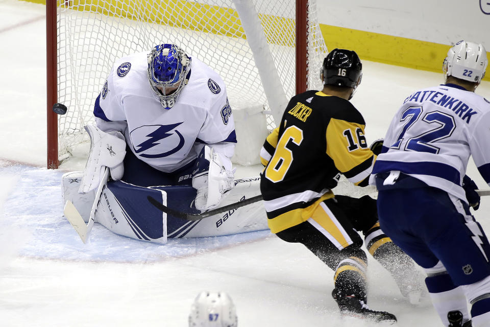 Tampa Bay Lightning goaltender Andrei Vasilevskiy (88) stops a shot by Pittsburgh Penguins' Jason Zucker (16) during the first period of an NHL hockey game in Pittsburgh, Tuesday, Feb. 11, 2020. (AP Photo/Gene J. Puskar)