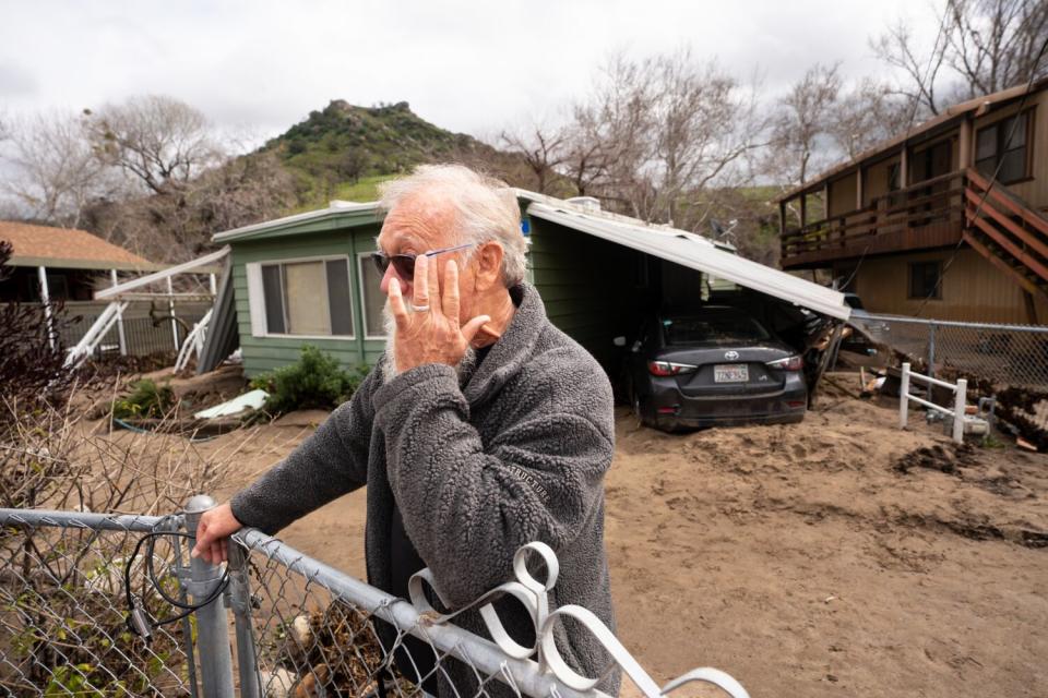 Bill Woodmansee tears up as he describes the damage to his home and rentals he owns. Woodmansee didn't have flood insurance.