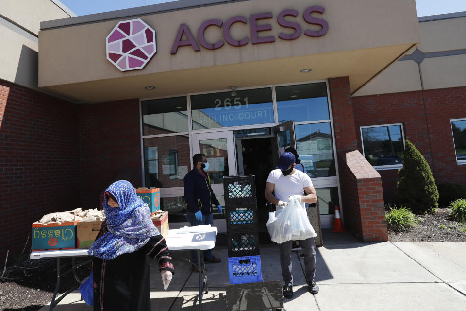 FILE - Workers at ACCESS, the Arab Community Center for Economic and Social Services, help with meals for the Arab community in Dearborn, Mich., May 1, 2020. For the first time in 27 years, the U.S. government on Thursday, March 28, 2024, changed how it categorizes people by race and ethnicity, an effort that federal officials believe will more accurately count residents who identify as Hispanic and of Middle Eastern and North African heritage. (AP Photo/Carlos Osorio, File)