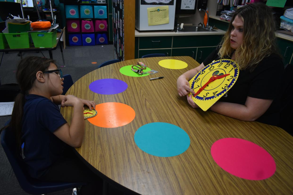 First grader, seven-year-old and student at Barnard Elementary School Mercedes Patterson learning to tell time from her teacher Holly Donaghey.