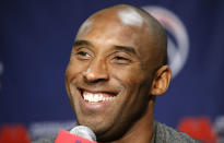 FILE - In this Nov. 26, 2013 file photo Los Angeles Lakers guard Kobe Bryant smiles during a media availability before an NBA basketball game against the Washington Wizards in Washington. The Retired NBA superstar has died in helicopter crash in Southern California, Sunday, Jan. 26, 2020. (AP Photo/Alex Brandon)