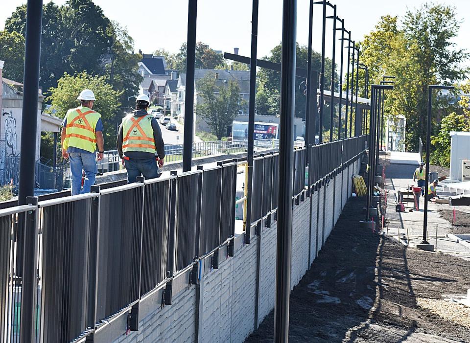 Workers are putting the finishing touches on the South Coast Rail station on Depot Street in Fall River.