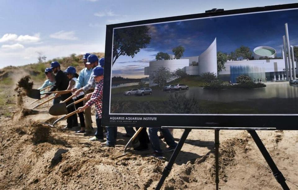 Dignitaries ceremoniously shovel dirt during a groundbreaking event for phase one of the Fresno aquarium planned west of Highway 99 at the San Joaquin River Wednesday, May 25, in Fresno.