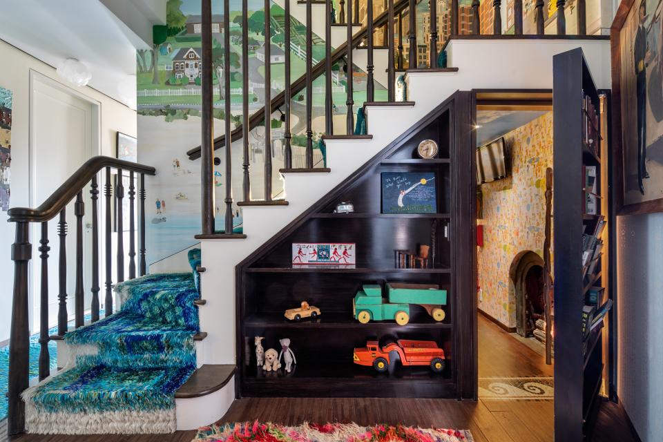 The home has two playrooms—one of which is located beneath a staircase and is decked out with monkey bars and an intercom to the second playroom.