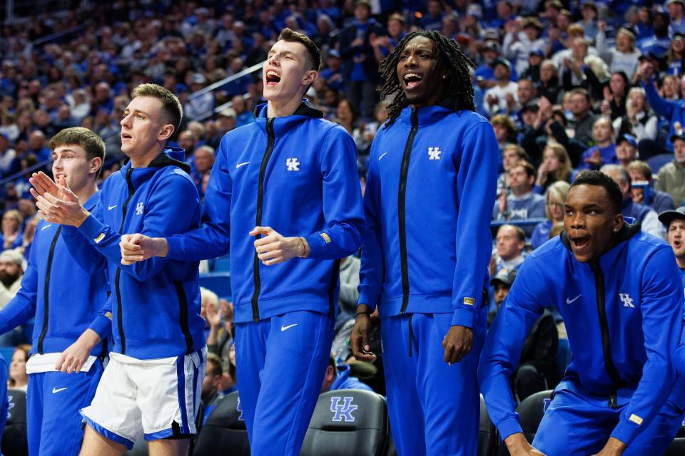 Kentucky players (from left) Joey Hart, Brennan Canada, Zvonimir Ivišić, Aaron Bradshaw and Ugonna Onyenso celebrate from the bench during the second half of the team's game against Saint Joseph's at Rupp Arena on Nov. 20. Bradshaw, Ivišić and Onyenso all are 7 foot (or taller). It's only the second time in program history it had three 7-footers on its roster in the same season.
