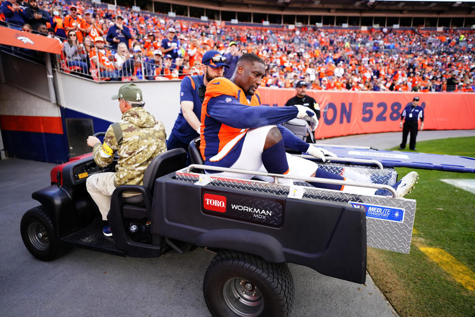 Denver Broncos offensive tackle Calvin Anderson (76) is carted off the field after an injury against the Los Angeles Chargers during the first half of an NFL football game, Sunday, Nov. 28, 2021, in Denver. (AP Photo/Jack Dempsey)