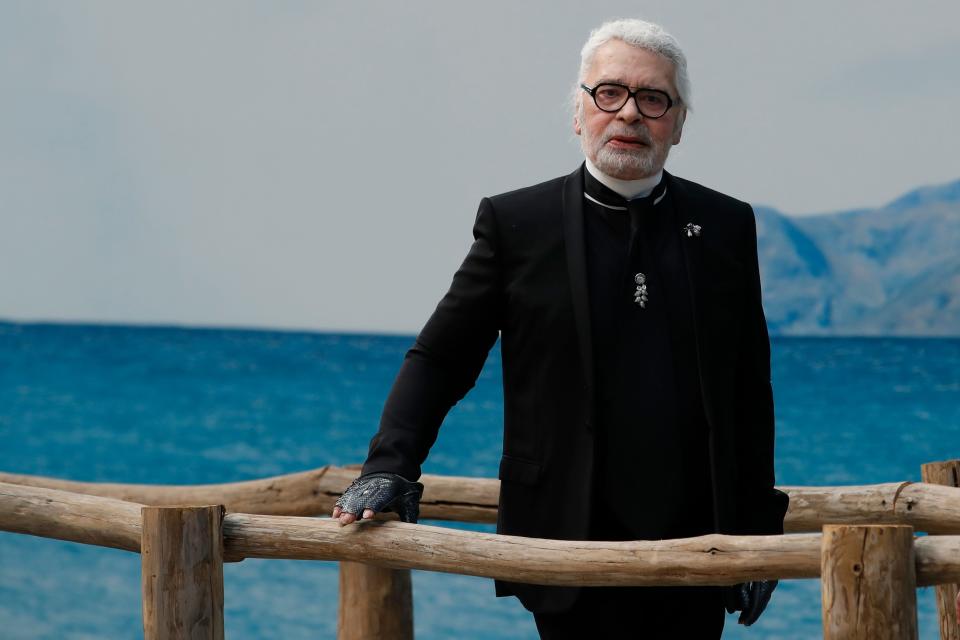 In this Tuesday, Oct.2, 2018 file photo, fashion designer Karl Lagerfeld poses after the presentation of Chanel Spring/Summer 2019 ready-to-wear fashion collection in Paris, Tuesday, Oct.2, 2018. Chanel's iconic couturier, Karl Lagerfeld, whose accomplished designs as well as trademark white ponytail, high starched collars and dark enigmatic glasses dominated high fashion for the last 50 years, has died. He was around 85 years old. 