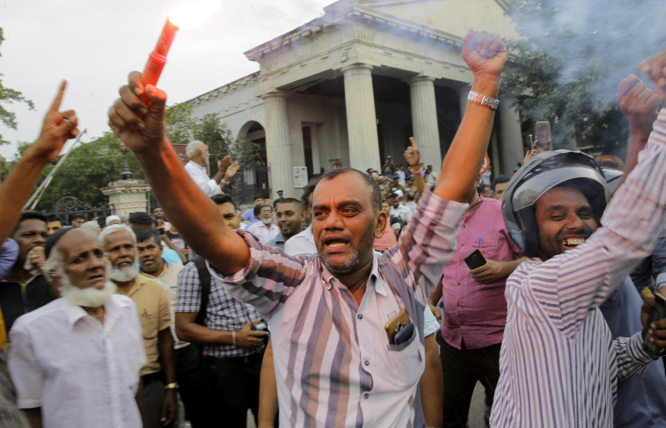 Supporters of ousted Sri Lankan Prime Minister Ranil Wickremesinghe celebrate outside the supreme court complex in Colombo, Sri Lanka, Thursday, Dec. 13, 2018. Sri Lanka's Supreme Court unanimously ruled as unconstitutional President Maithripala Sirisena's order to dissolve Parliament and call for fresh elections, a much-anticipated verdict Thursday that further embroils the Indian Ocean island nation in political crisis.(AP Photo/Eranga Jayawardena)