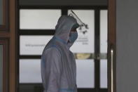 A health worker walks inside a quarantine facility for people showing symptoms of the COVID-19 amid the coronavirus outbreak at Patriot Candrabhaga stadium in Bekasi on the outskirts of Jakarta, Indonesia, Tuesday, Sept. 22, 2020.(AP Photo/Achmad Ibrahim)