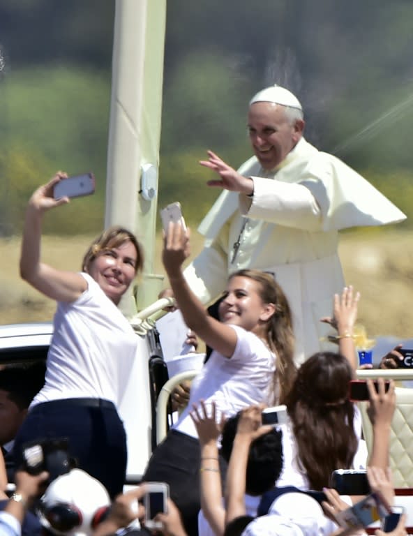 Pope Francis waves at the crowd of faithful gathering for an open-air mass at Samanes Park in Guayaquil, Ecuador on July 6, 2015