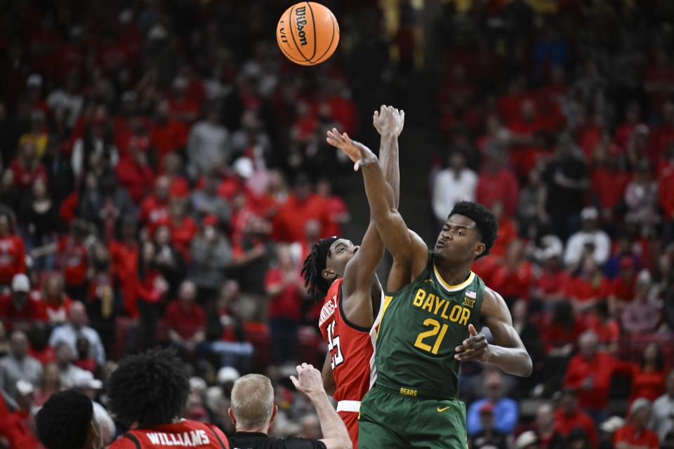 Baylor center Yves Missi (21) and Texas Tech forward Robert Jennings go up for the tipoff during the first half of an NCAA college basketball game Saturday, March 9, 2024, in Lubbock, Texas. (AP Photo/Justin Rex)