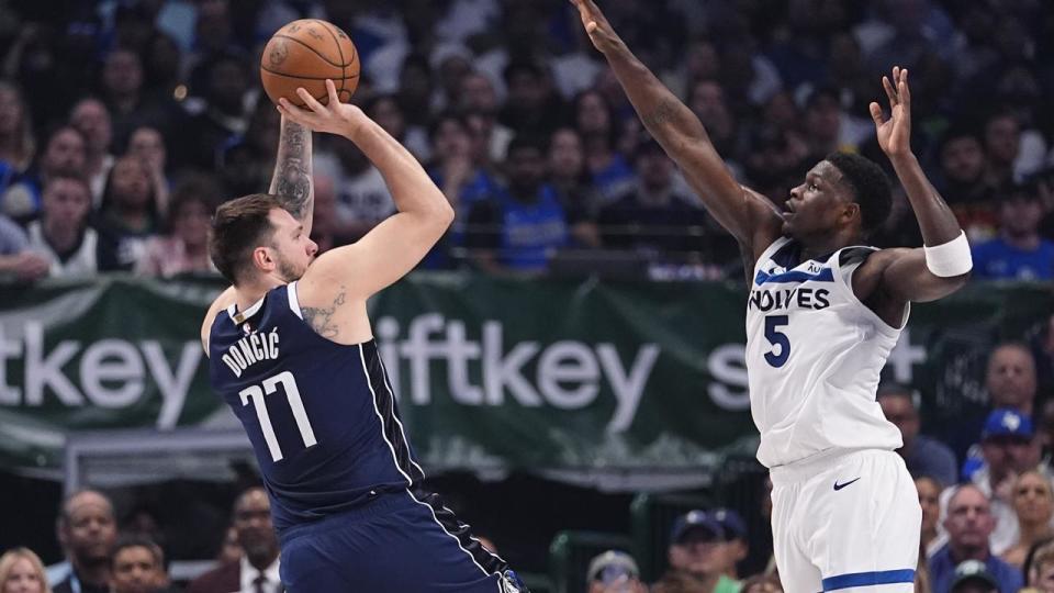 Luka Doncic (77) shoots against Minnesota's Anthony Edwards.