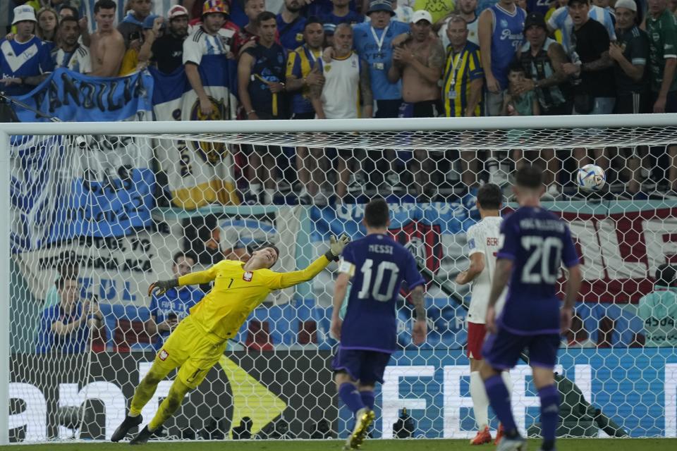 Poland's goalkeeper Wojciech Szczesny, left, fails to save a shot by Argentina's Julian Alvarez during the World Cup group C soccer match between Poland and Argentina at the Stadium 974 in Doha, Qatar, Wednesday, Nov. 30, 2022. (AP Photo/Jorge Saenz)