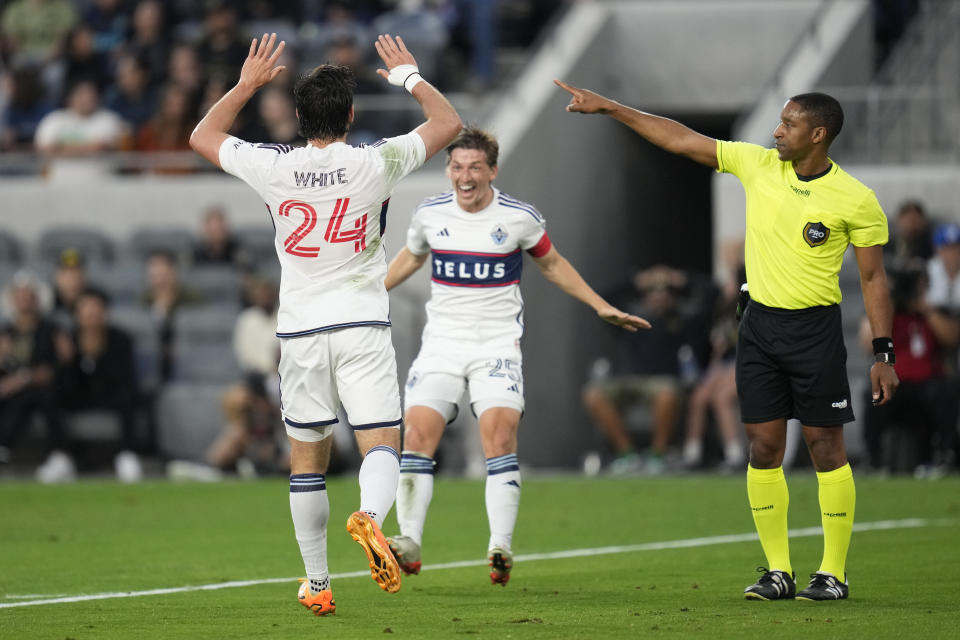 Vancouver Whitecaps forward Brian White (24) celebrates with midfielder Ryan Gauld (25) after scoring during the first half of an MLS soccer match against Los Angeles FC in Los Angeles, Saturday, June 24, 2023. (AP Photo/Ashley Landis)