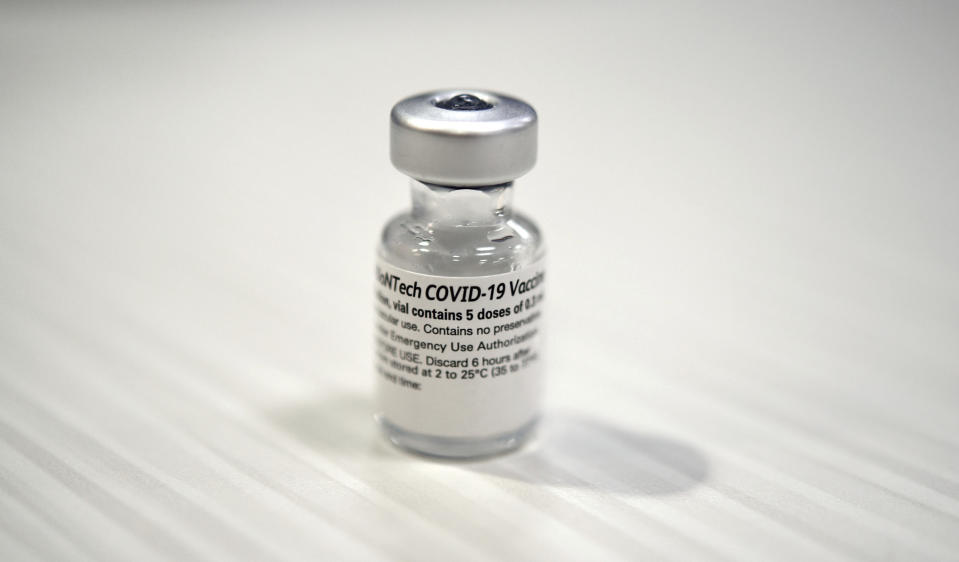 One of the first vials of the Pfizer BioNTech COVID-19 vaccine at Wake Forest Baptist Medical Center, Tuesday, Dec. 15, 2020. Wake Forest Baptist received its first shipment of the Pfizer vaccine on Monday morning. Ten employees received the first dose of the Pfizer vaccine Tuesday. Additional employees will be given the vaccine in the coming days. (Walt Unks/The Winston-Salem Journal via AP)