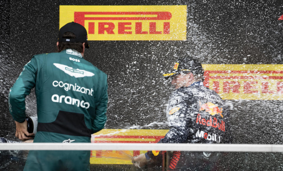 Winner Red Bull Racing's Max Verstappen, of the Netherlands, is sprayed with champagne by second place finisher Aston Martin driver Fernando Alonso of Spain, during victory ceremonies following the Formula One Canadian Grand Prix auto race, Sunday, July 18, 2023, in Montreal. (Paul Chiasson/The Canadian Press via AP)