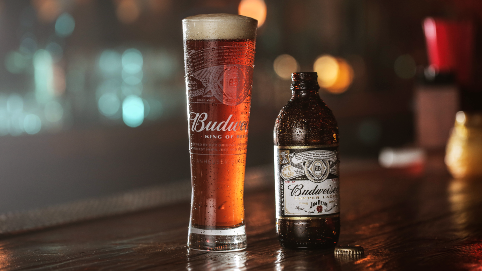 A glass and bottle of Budweiser