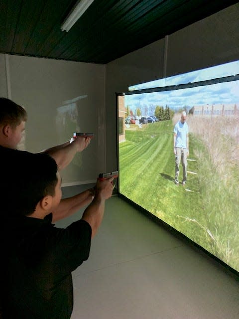 Angel Gomez (foreground) and Julian Aldridge take their turn at the MILO training unit last month at the St. Joseph County Sheriff’s Department. They are a part of the Sturgis Explorers Program.