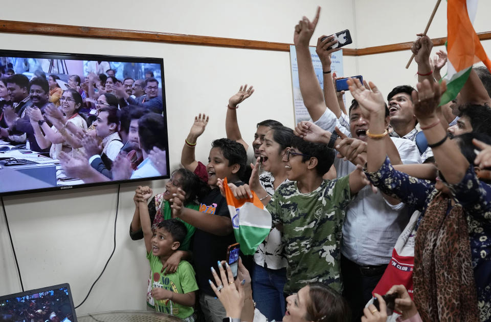 Schoolchildren cheer as they watch the successful landing of Chandrayaan-3, or 