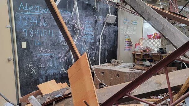 PHOTO: Amid the debris from the storm, a chalkboard listing the students on 'scribe' duty for the day remains unscratched. (Amanda McCloud)