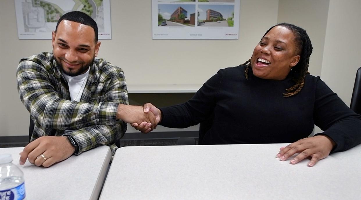Luis Berrio, left, and Tiff Lowe share a moment during an interview about how Berrio's new life is woven into the Group Violence Initiative to help others.