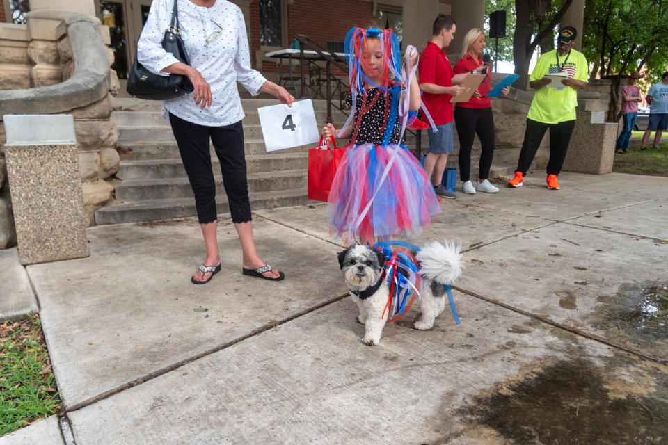 Holland Steinle and her pet Bugsy take home the owner/pet look alike award  Saturday at the Center City 3rd annual Patritic Pet Parade in downtown Amarillo.