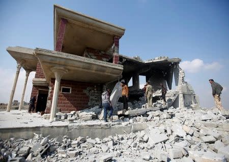 Sunni Arab fighters gather at a house, which the residents of the village said belonged to a man who joined the Islamic State militants and was destroyed in an explosion, in Rfaila village in south of Mosul, Iraq, February 17, 2017. Picture taken February 17, 2017. REUTERS/Khalid al Mousily