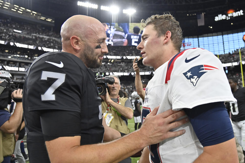 Las Vegas Raiders quarterback Brian Hoyer, left, greets New England Patriots quarterback Mac Jones after the Raiders defeated the Patriots 21-17 in an NFL football game Sunday, Oct. 15, 2023, in Las Vegas. (AP Photo/David Becker)