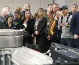 Travelers wait for their luggage to arrive in Denver International Airport Wednesday, Nov. 21, 2018, in Denver. Mild weather in parts of the country and lower gasoline prices have potentially created one of the busiest Thanksgiving Day travel periods since 2005, according to AAA. (AP Photo/David Zalubowski)