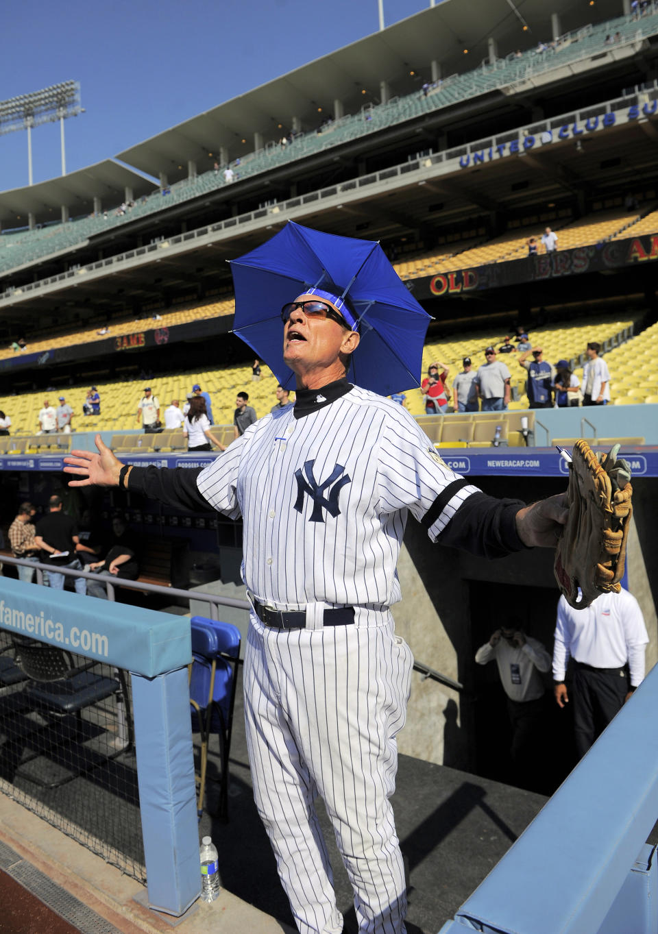 FILE- In this June 8, 2013, file photo, Jay Johnstone walks out of the dugout during batting practice prior to the Old-Timers baseball game in Los Angeles. Johnstone, who won World Series championships as a versatile outfielder with the New York Yankees and Los Angeles Dodgers while being baseball’s merry prankster, died Saturday, Sept. 26, of complications from COVID-19 at a nursing home in Granada Hills, Calif., his daughter Mary Jayne Sarah Johnstone said Monday, Sept. 28, 2020. He was 74. He also from dementia in recent years, his daughter said. (AP Photo/Mark J. Terrill, File)