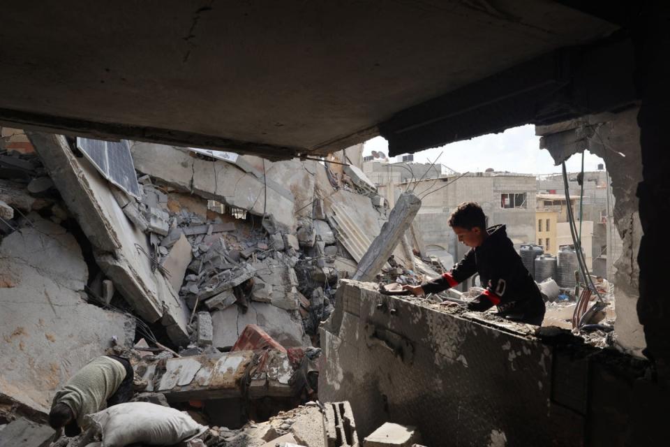 Palestinians inspect the damage following Israeli bombardment of Rafah's Tal al-Sultan district in the southern Gaza Strip (AFP/Getty)