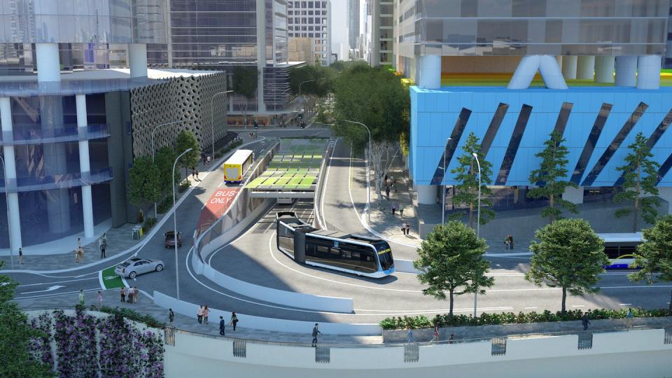 Artist impression of a Brisbane Metro electric bus emerging from a city tunnel, with an older bus on the ramp. Brisbane City Council.