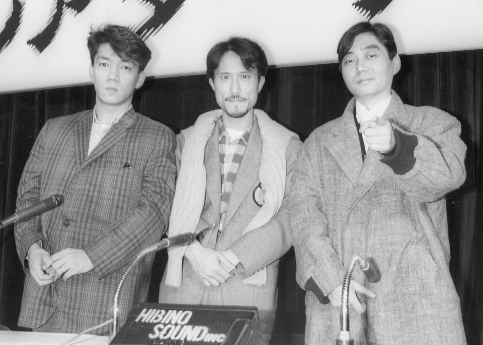 YMO members, Ryuichi Sakamoto, left, Yukihiro Takahashi, center, and Haruomi Hosono pose at a press conference for their movie in Tokyo, April 5, 1984. Japan's recording company Avex says Sakamoto, a musician who scored for Hollywood movies such as “The Last Emperor” and “The Revenant,” has died. He was 71. He died March 28, according to the statement released Sunday, April 2, 2023. (Kyodo News via AP)