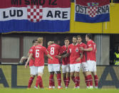 Austria's Christoph Baumgartner celebrates with teammates after scoring his side's opening goal during the UEFA Nations League soccer match between Austria and Croatia at the Ernst Happel Stadion in Vienna, Austria, Sunday, Sept. 25, 2022. (AP Photo/Florian Schroetter)
