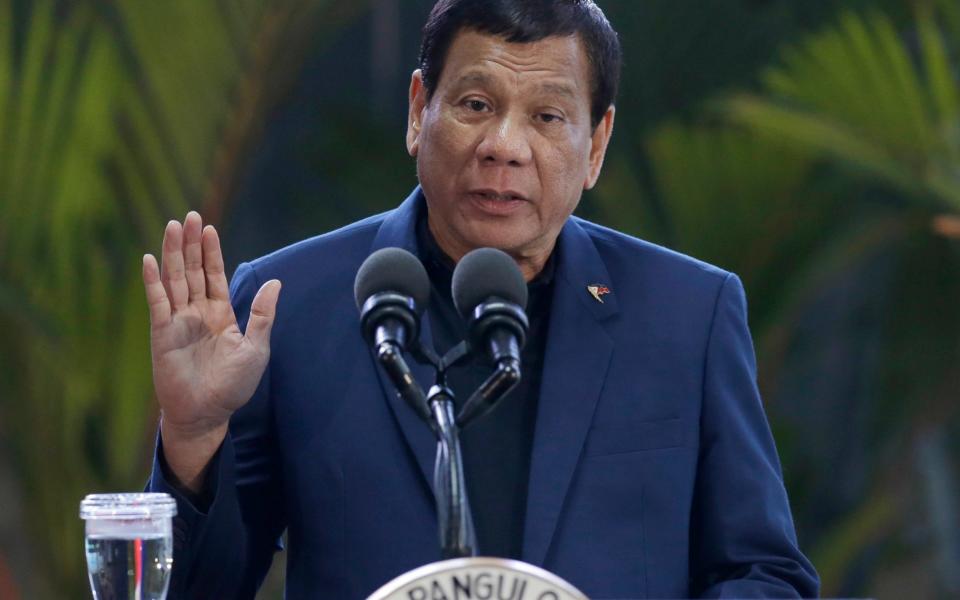 Philippine President Rodrigo Duterte gestures as he answers questions from reporters at Manila's international airport, Philippines, Wednesday, May 24 - Credit: Aaron Favila/AP