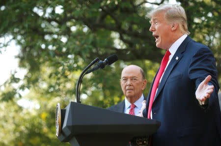 U.S. President Donald Trump announces the United States-Mexico-Canada Agreement (USMCA) as U.S. Commerce Secretary Wilbur Ross looks on during a news conference in the Rose Garden of the White House in Washington, U.S., October 1, 2018. REUTERS/Leah Millis