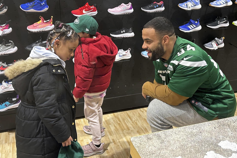 New York Jets defensive lineman Solomon Thomas chats with a student from Brooklyn Community Services Jets' Academy during a holiday shopping spree hosted by the team at Dick's Sporting Goods in East Hanover, N.J., on Tuesday, Dec. 12, 2023. (AP Photo/Dennis Waszak Jr.)