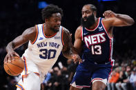 New York Knicks forward Julius Randle (30) drives against Brooklyn Nets guard James Harden (13) during the first half of an NBA basketball game, Tuesday, Nov. 30, 2021, in New York. (AP Photo/Mary Altaffer)