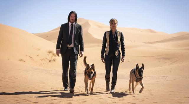 Keanu Reeves and Halle Berry with good boy pals in John Wick 3 (credit: Lionsgate)