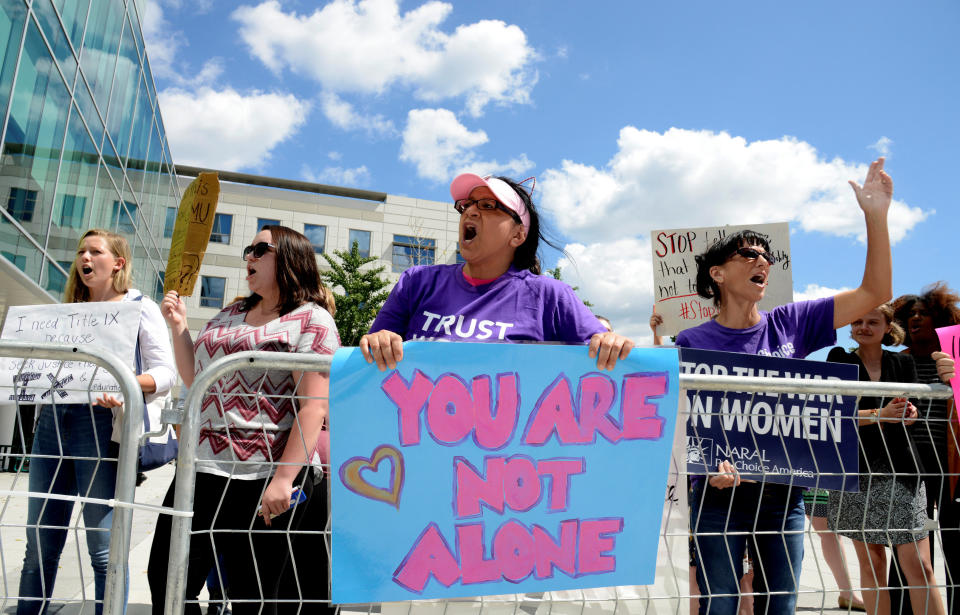 A group of demonstrators gather outside Founders Hall where DeVos delivered a major policy address on Title IX enforcement at George Mason University in Arlington, Virginia, on Sept. 7, 2017. (Photo: Mike Theiler / Reuters)