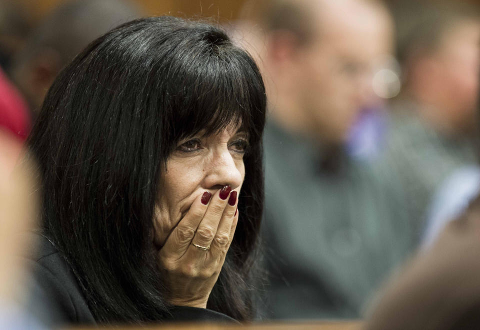 Close family friend of Reeva Steenkamp, Desiree Myers, puts her hand to her mouth while listening to cross questioning about the events surrounding the shooting death of Oscar Pistroius girlfriend Steenkamp, during Pistroius' trial in Pretoria, South Africa, Friday, March 7, 2014. Pistorius is charged with murder for the shooting death of Steenkamp, on Valentines Day in 2013. (AP Photo/Theana Breugem, Pool)