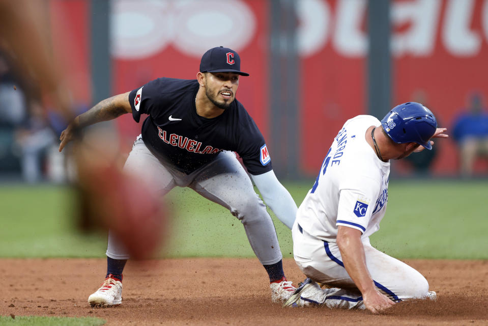 Cleveland Guardians second baseman Andrés Giménez, left, tags out Kansas City Royals' Hunter Renfroe at second to complete a double play, after Maikel Garcia grounded out to first during the third inning of a baseball game in Kansas City, Mo., Thursday, June 27, 2024. (AP Photo/Colin E. Braley)