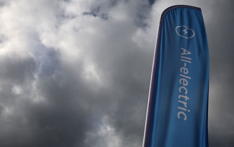 A sign advertising electric vehicles for sale is seen outside the showroom of a used car dealer in Manchester