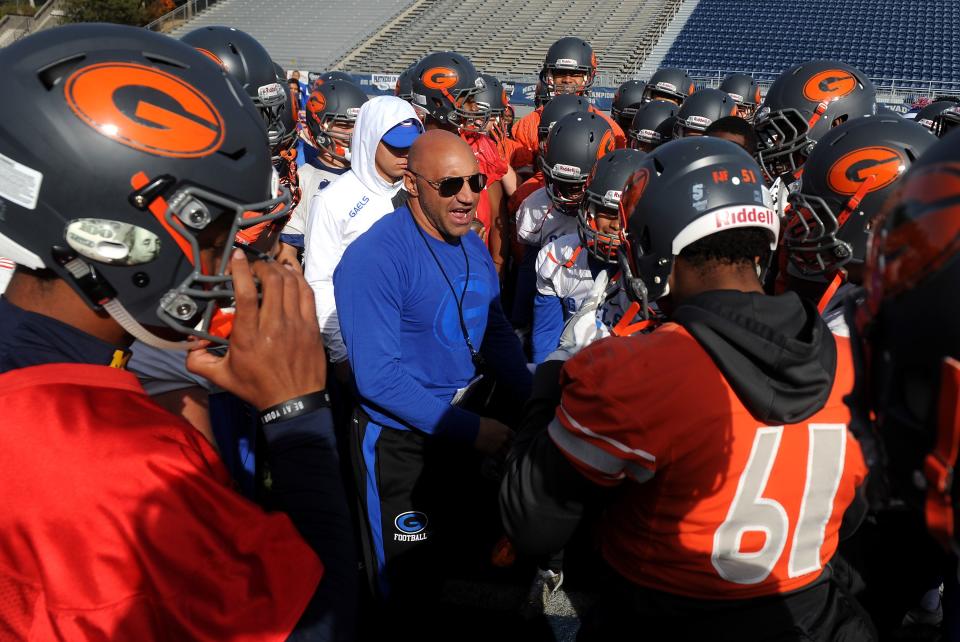 Bishop Gorman head football coach Kenny Sanchez, middle, talks with his players during practice in preparation for the state championship game against Reed at Mackay Stadium in Reno on Dec. 1, 2017.