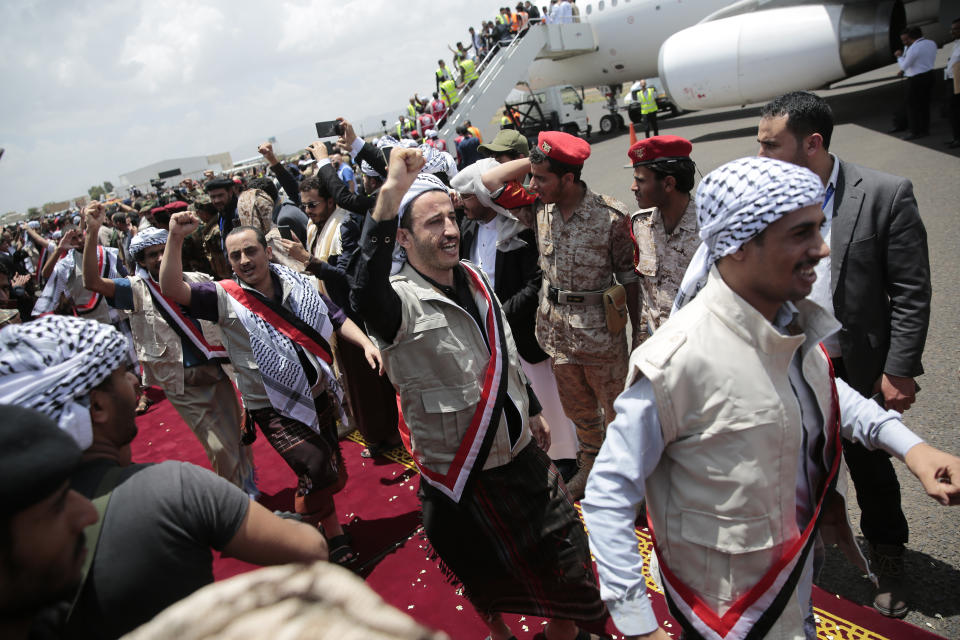 Houthi prisoners cheers as they arrive to Sanaa airport, Friday, April 14, 2023. An exchange of more than 800 prisoners linked to Yemen's long-running war them began Friday, the International Committee for the Red Cross said. The three-day operations will see flights transport prisoners between Saudi Arabia and Yemen's capital, Sanaa, long held by the Iranian-backed Houthi rebels. ((AP Photo/Hani Mohammed)