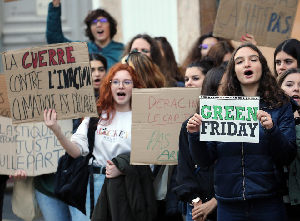 Young people protests against Black Friday, Nov 29, 2019, in Bayonne, southwestern France. Placard at left reads "The war against climate inaction is engaged". Some French lawmakers want to ban the Black Friday sales, the post-Thanksgiving sales event that has morphed into a global phenomenon. (AP Photo/Bob Edme)