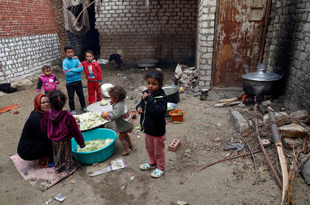 An Egyptian mother prepares a cabbage meal with her children in the province of Fayoum, southwest of Cairo, Egypt February 19, 2019. Picture taken February 19, 2019. REUTERS/Hayam Adel