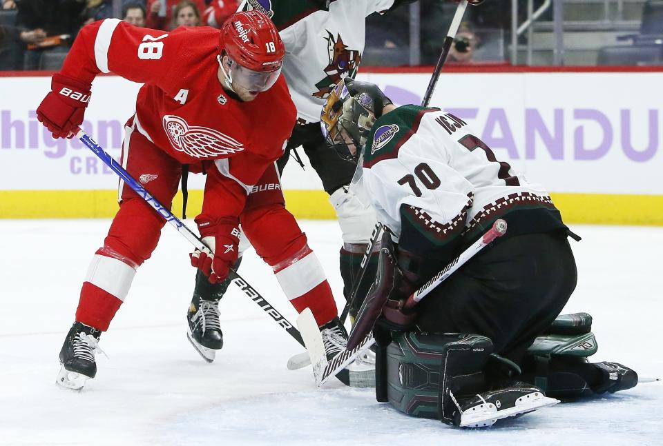 Detroit Red Wings center Andrew Copp (18) shoots against Arizona Coyotes goaltender Karel Vejmelka (70) during the first period of an NHL hockey game Friday, Nov. 25, 2022, in Detroit. (AP Photo/Duane Burleson)