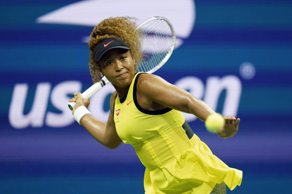 Naomi Osaka, of Japan, returns a shot to Marie Bouzkova, of the Czech Republic, during the first round of the US Open tennis championships, Monday, Aug. 30, 2021, in New York. (AP Photo/Elise Amendola)